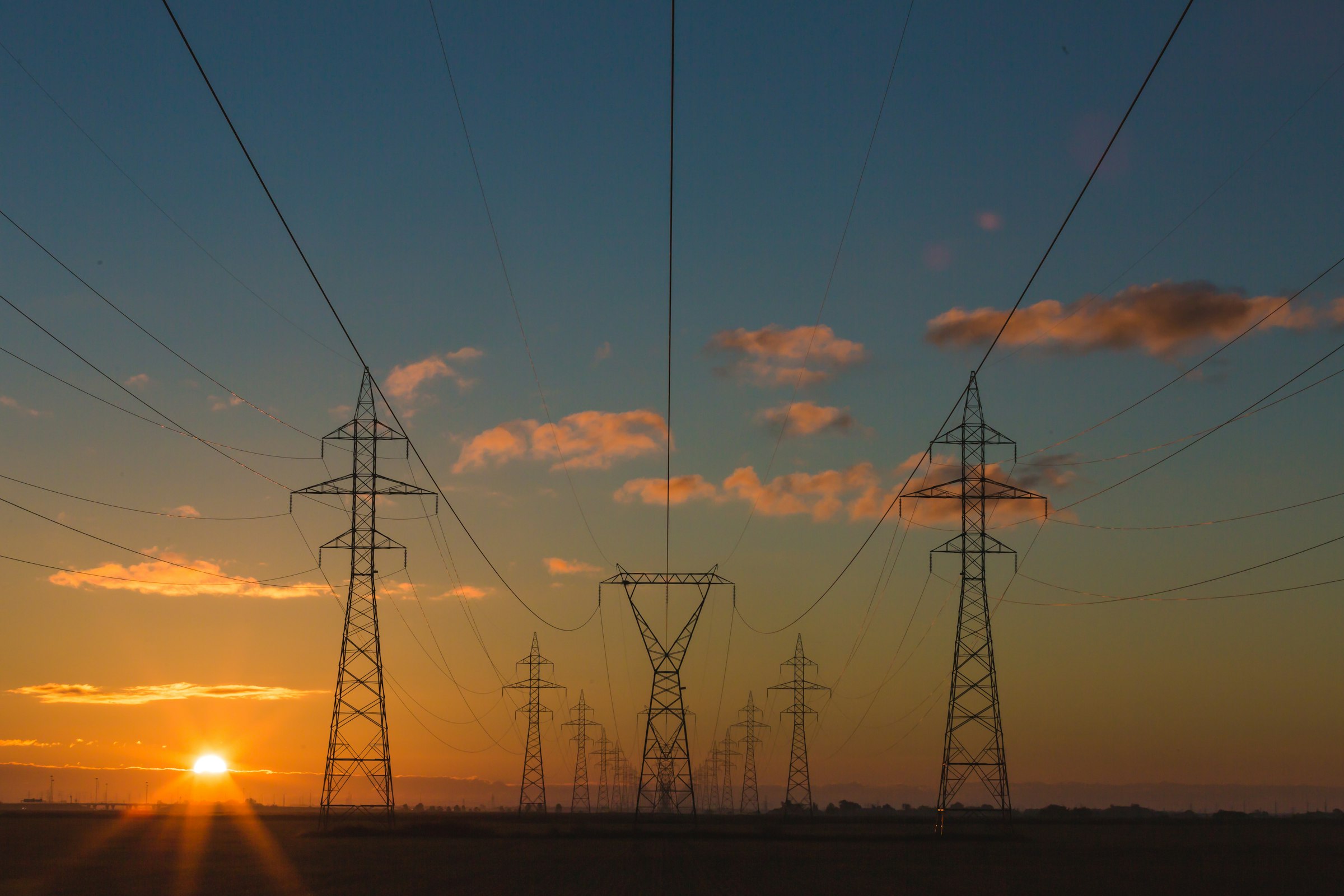 Energy storage infrastructure at dusk. Stand-in for impact-ops context in early-career hiring notes.